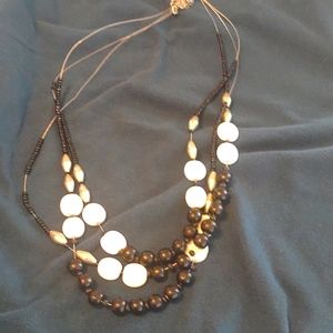 Necklace about 22" long total length - ebony and ivory beads with silver tone ac